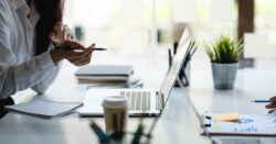 Close-up images of two office workers reviewing graphs and working on a laptop, illustrating CapinCrouse fraud prevention best practices resource