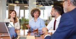 Nonprofit leaders in discussion at a conference table, illustrating the importance of nonprofit gift acceptance considerations.